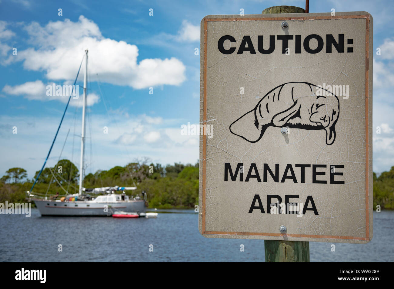 Yacht / sail boat and Manatee warning sign, Florida Stock Photo