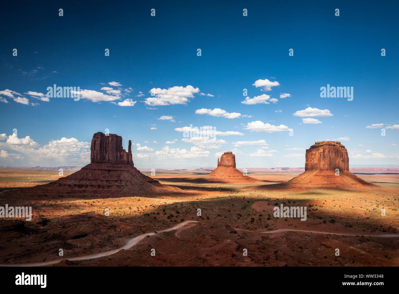 Shadows fall across the iconic stone formations at Monument Valley, AZ Stock Photo