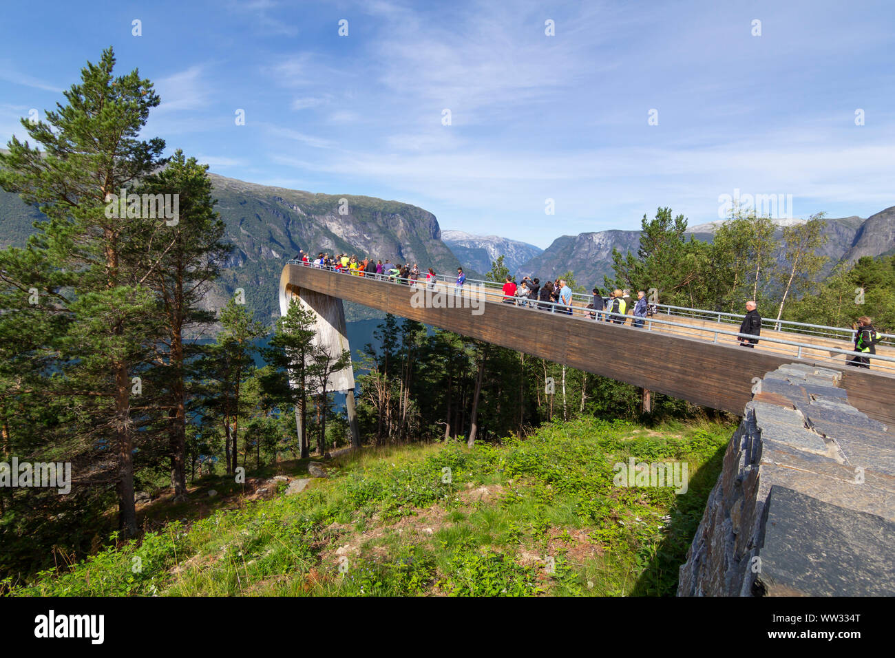 People looking at Aurlandsfjord from the top of Stegastein viewpoint platform, a modern architecture lookout with maje Stock Photo