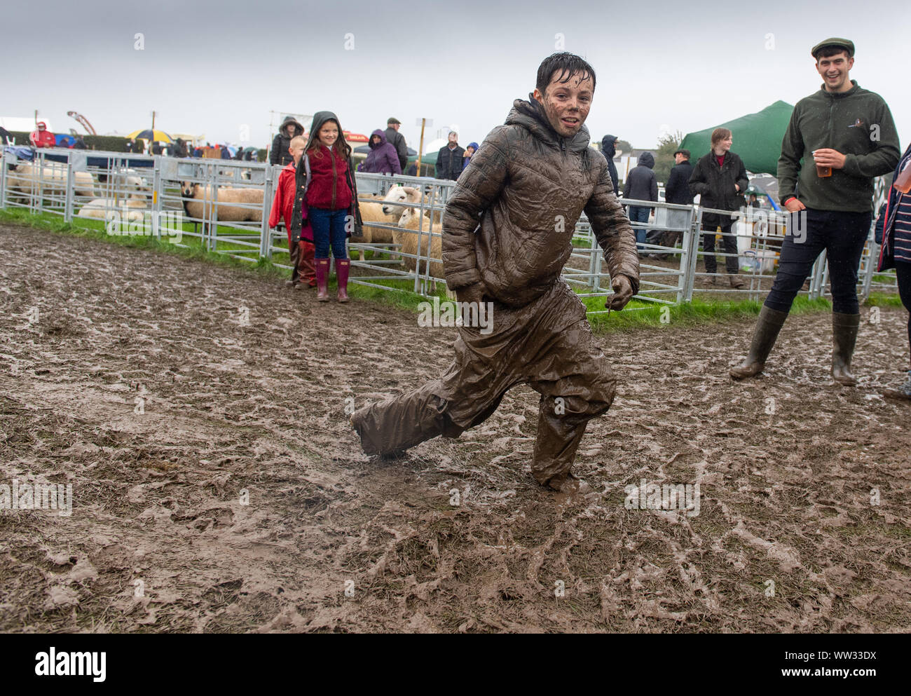 Kendal, Cumbria, UK. 12th Sep 2019. The weather conditions didnt dampen the spirits of everyone at the Westmorland County show, Kendal, Cumbria, as this young lad showed, enjoying a mud slide. Not sure his parents enjoyed it as much as he did! Credit: Wayne HUTCHINSON/Alamy Live News Stock Photo