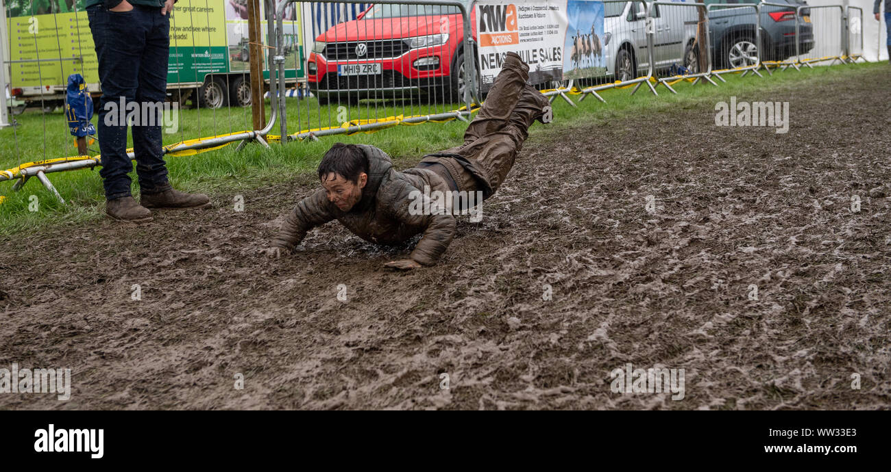 Kendal, Cumbria, UK. 12th Sep 2019. The weather conditions didnt dampen the spirits of everyone at the Westmorland County show, Kendal, Cumbria, as this young lad showed, enjoying a mud slide. Not sure his parents enjoyed it as much as he did! Credit: Wayne HUTCHINSON/Alamy Live News Stock Photo