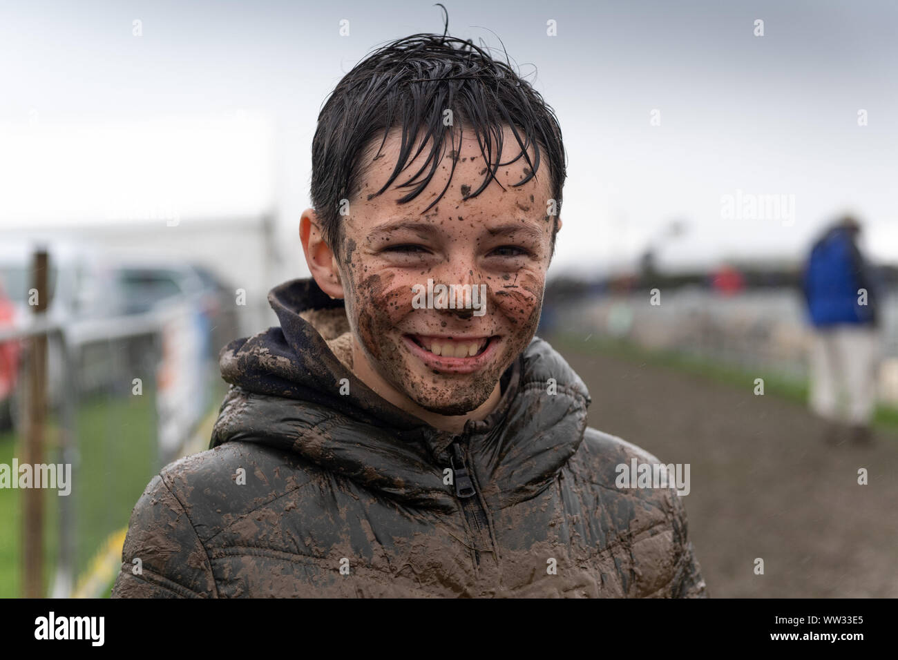 Kendal, Cumbria, UK. 12th Sep 2019. The weather conditions didnt dampen the spirits of everyone at the Westmorland County show, Kendal, Cumbria, as this young lad showed, enjoying a mud slide. Not sure his parents enjoyed it as much as he did! Credit: Wayne HUTCHINSON/Alamy Live News Stock Photo