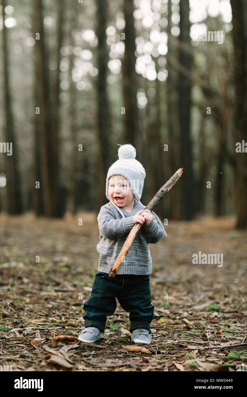 Toddler boy in woods with winter hat Stock Photo