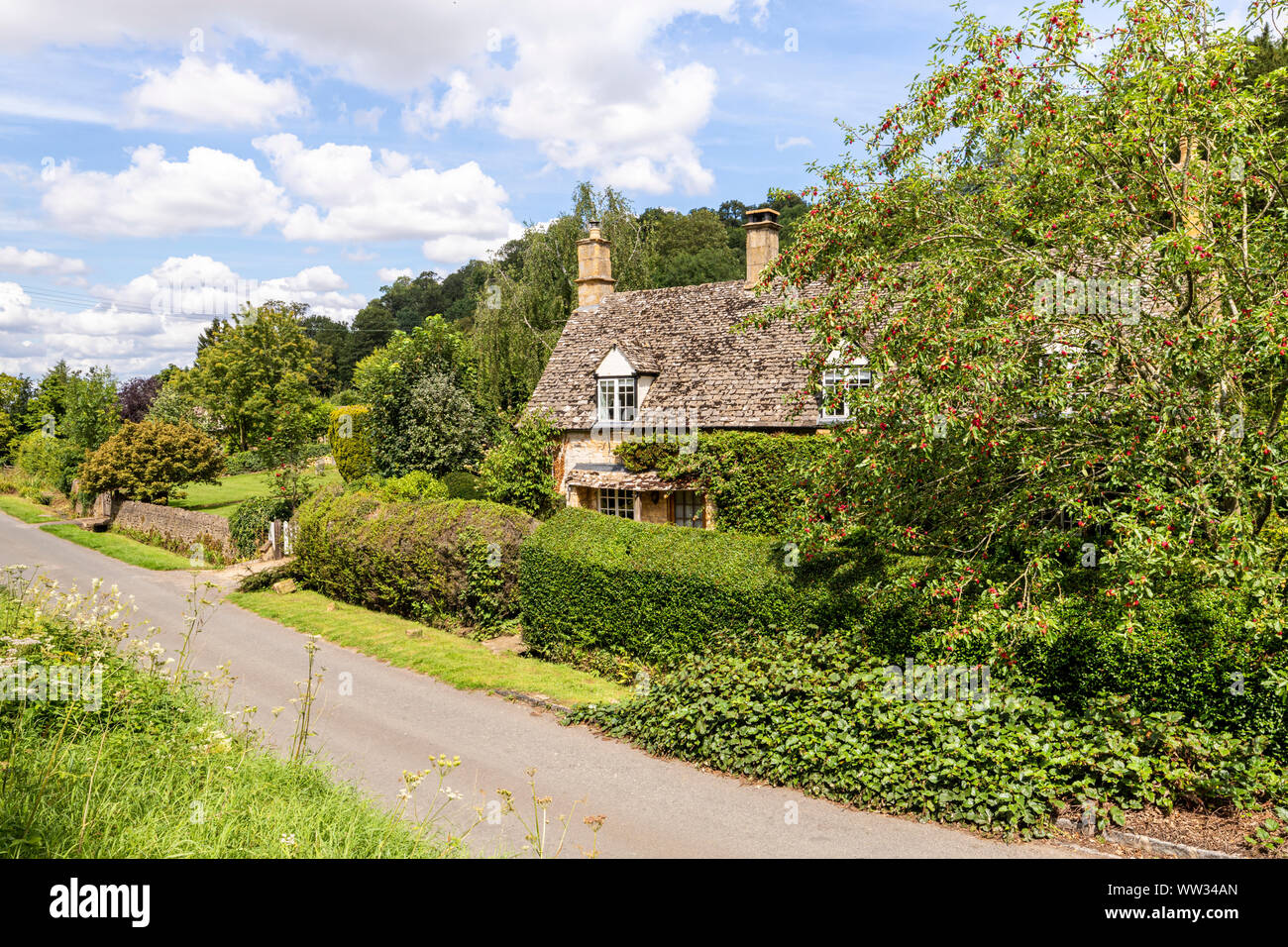 A cottage beside the lane in the Cotswold village of Buckland, Gloucestershire UK Stock Photo
