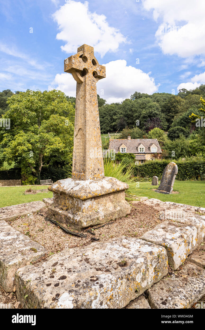 Victorian Celtic churchyard cross on a medieval base in the churchyard of St Michaels church in the Cotswold village of Buckland, Gloucestershire UK Stock Photo