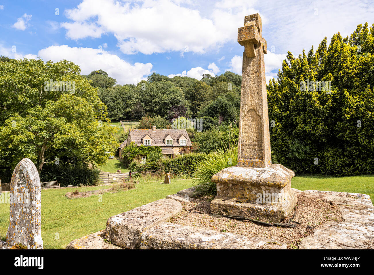 Victorian Celtic churchyard cross on a medieval base in the churchyard of St Michaels church in the Cotswold village of Buckland, Gloucestershire UK Stock Photo