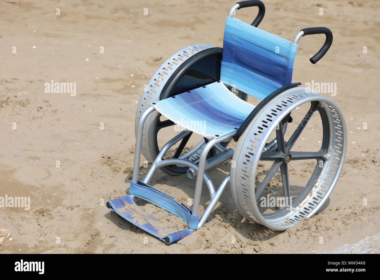 wheelchair on the sand of the beach in summer Stock Photo Alamy
