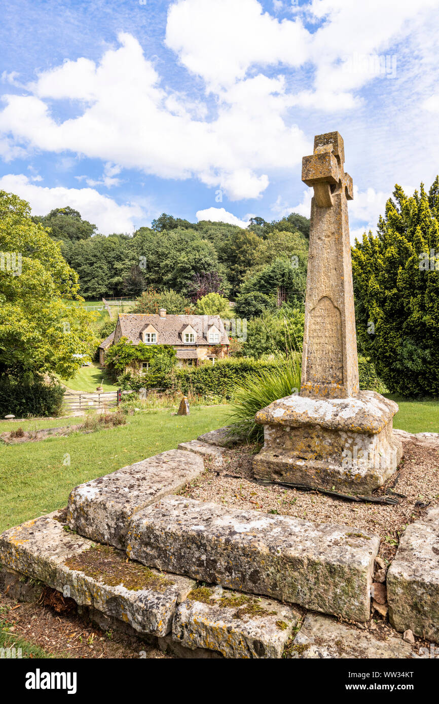 Victorian Celtic churchyard cross on a medieval base in the churchyard of St Michaels church in the Cotswold village of Buckland, Gloucestershire UK Stock Photo