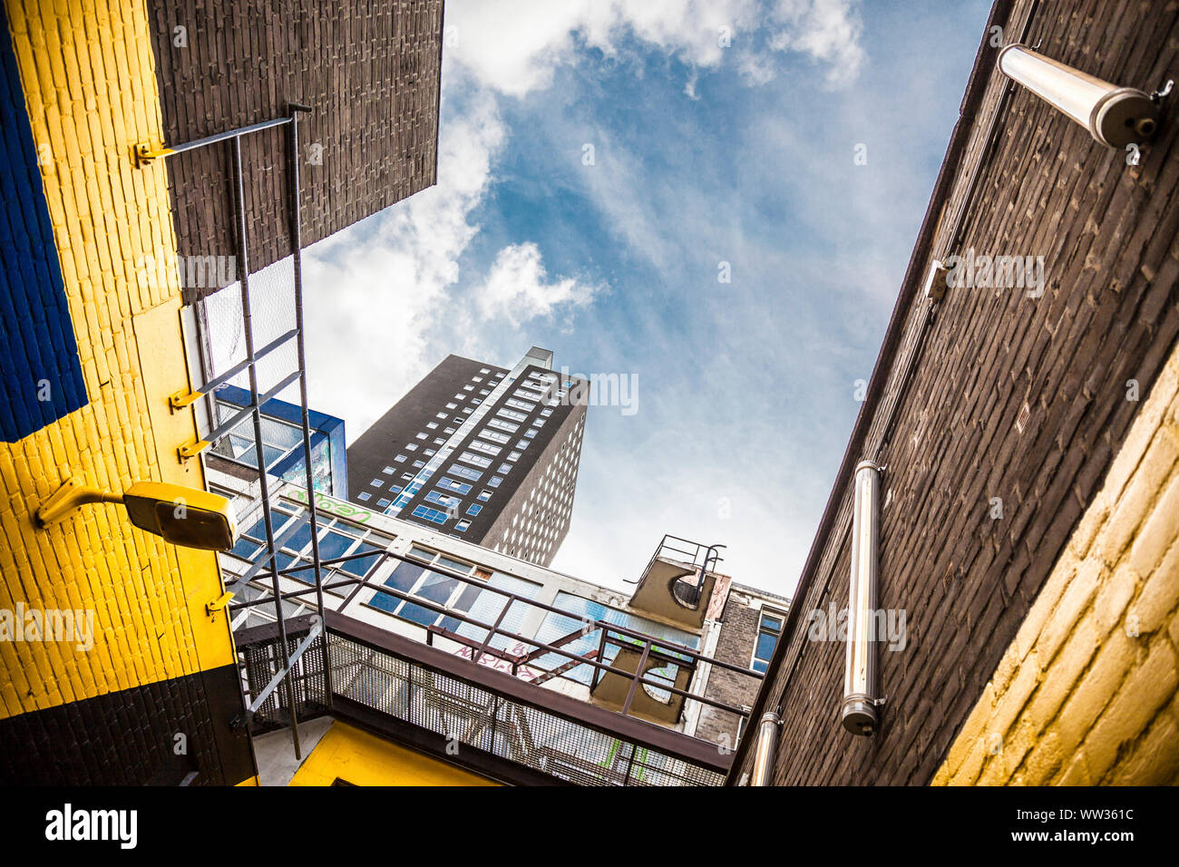 Urban view in Rotterdam with yellow walls and a skyscraper Stock Photo