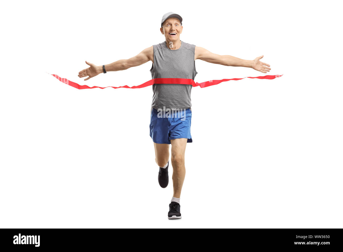 Full length portrait of a happy senior man on the finish of a marathon race isolated on white background Stock Photo
