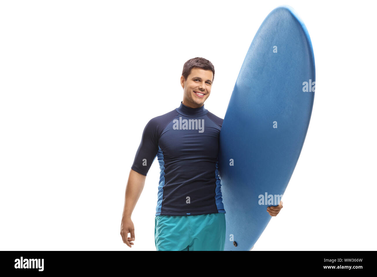 Young male surfer holding a surfboard and smiling at the camera isolated on white background Stock Photo