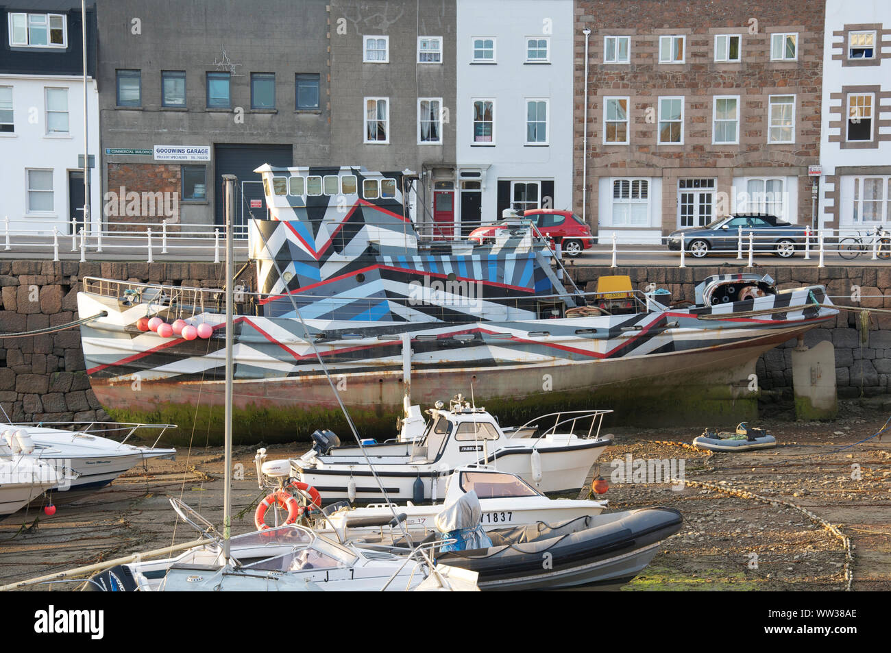 The tugboat Elektra painted in a dazzle camouflage design by artists Matt Daly and Ian Rolls, commemorating the centenary of WW1. St Helier, Jersey. Stock Photo