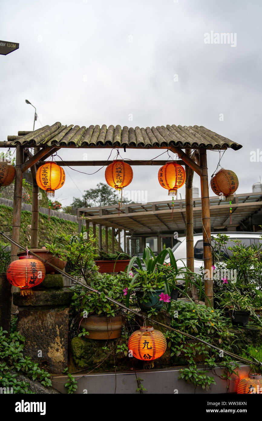 Jiufen: Orange, traditional chinese lanterns hanging on Bamboo garden roof at evening Stock Photo