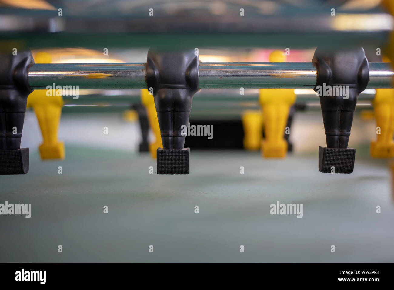 Close-up of a football table with yellow and black figures Stock Photo