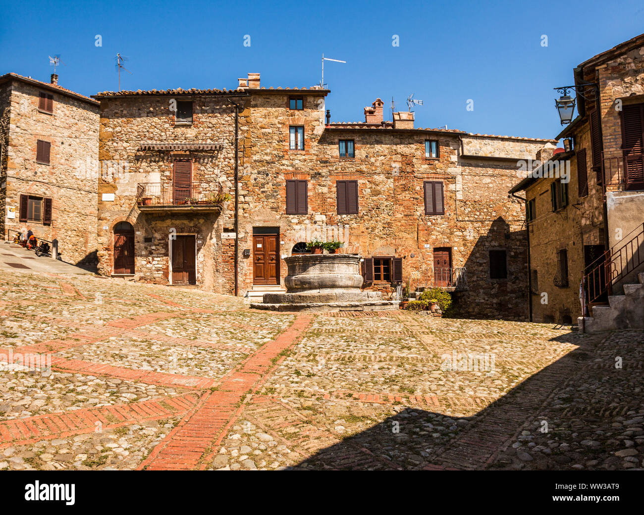 A typical small square of Castiglione d’Orcia, an ancient village in ...