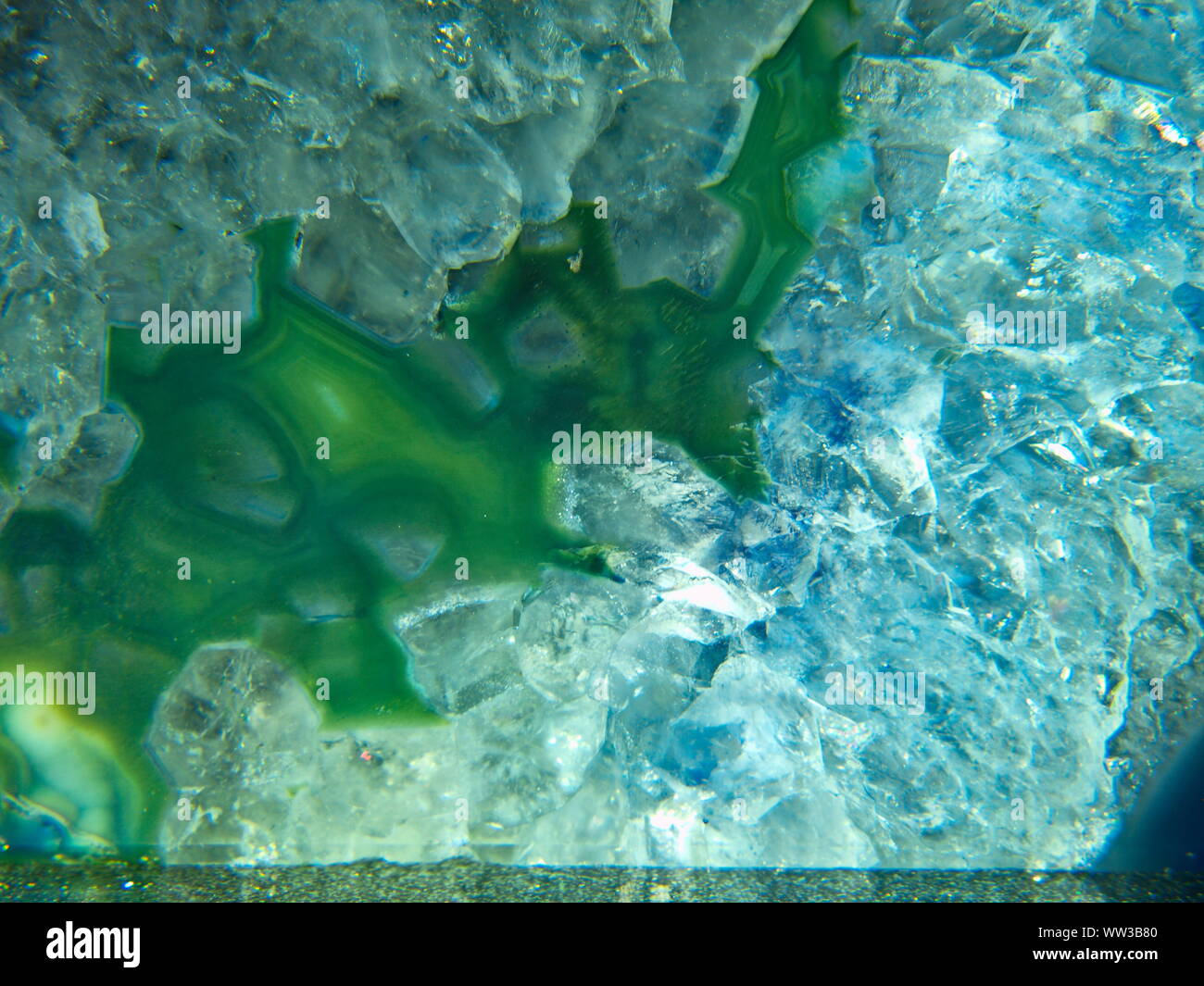 A closeup-macro photograph of a green agate Geode crystal geological formation Stock Photo