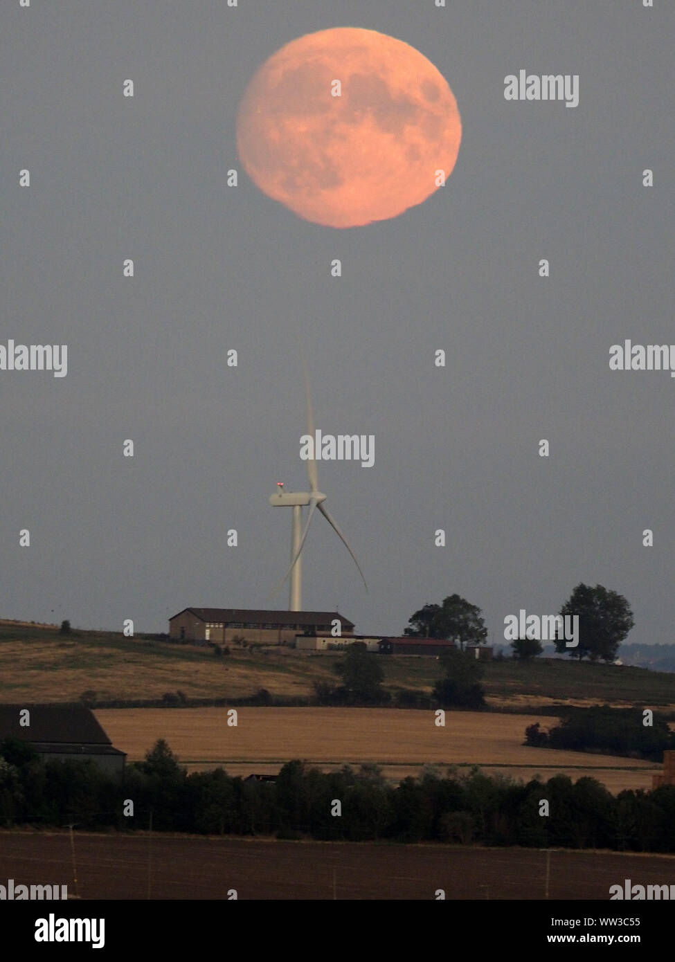 Halfway Houses, Sheerness, Kent, UK. 12th September, 2019. UK Weather: the 98% waxing gibbous moon rising over farmland on the Isle of Sheppey in Kent as seen from Halway Houses, Sheerness. Tomorrow will see a full moon - the first on Friday 13th for a number of years. The September full moon is known as the Harvest Moon. Credit: James Bell/Alamy Live News Stock Photo