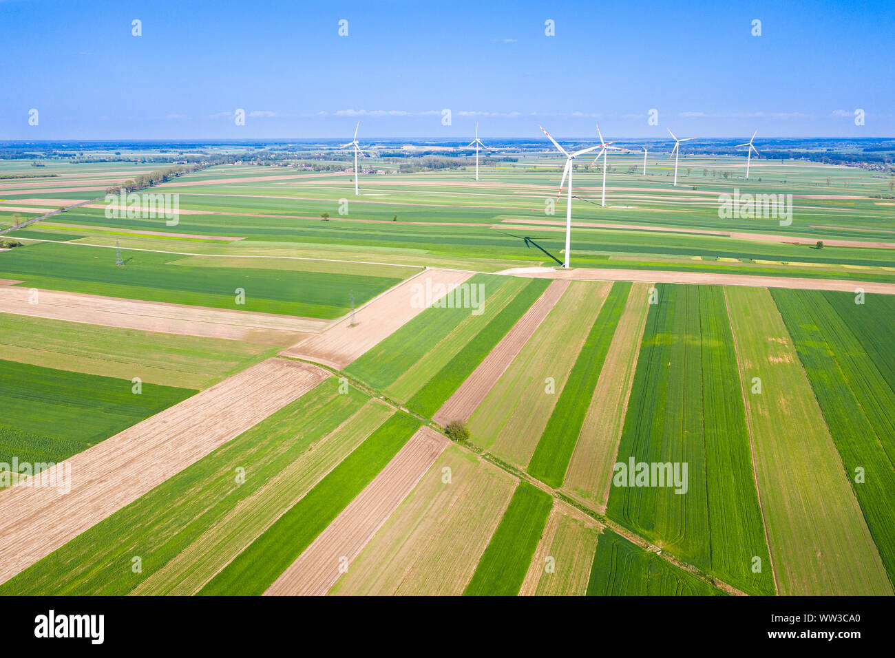wind turbines among fields seen from above Stock Photo