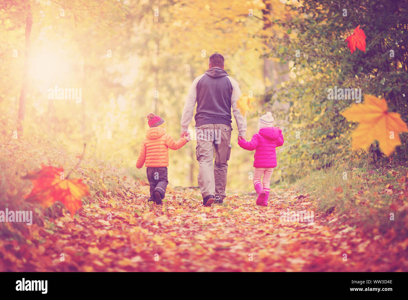 boy and girl with father holding hands on the nature Stock Photo - Alamy