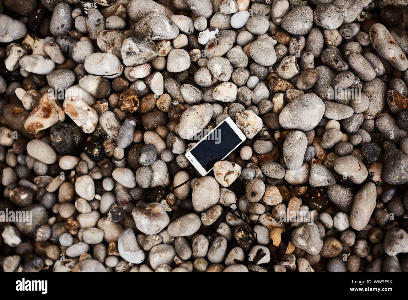 Smartphone laying on the pebble shore Stock Photo