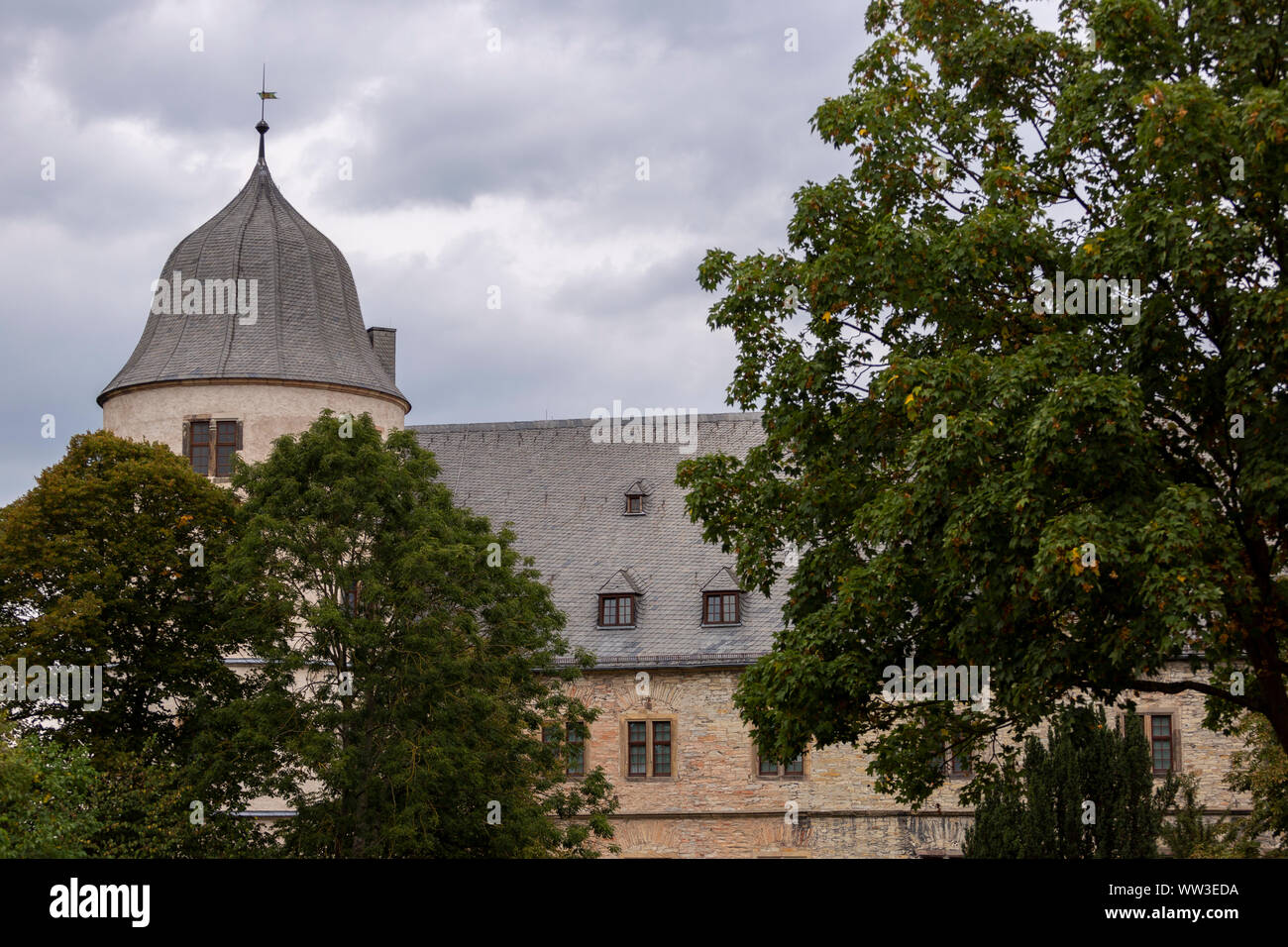 Wewelsburg castle behind the trees against an overcast cloudy sky Stock Photo