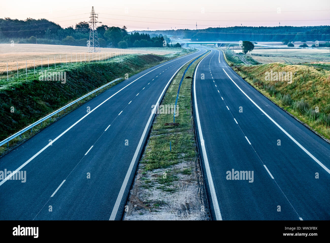 empty two-lane road stretching out into the horizon Stock Photo
