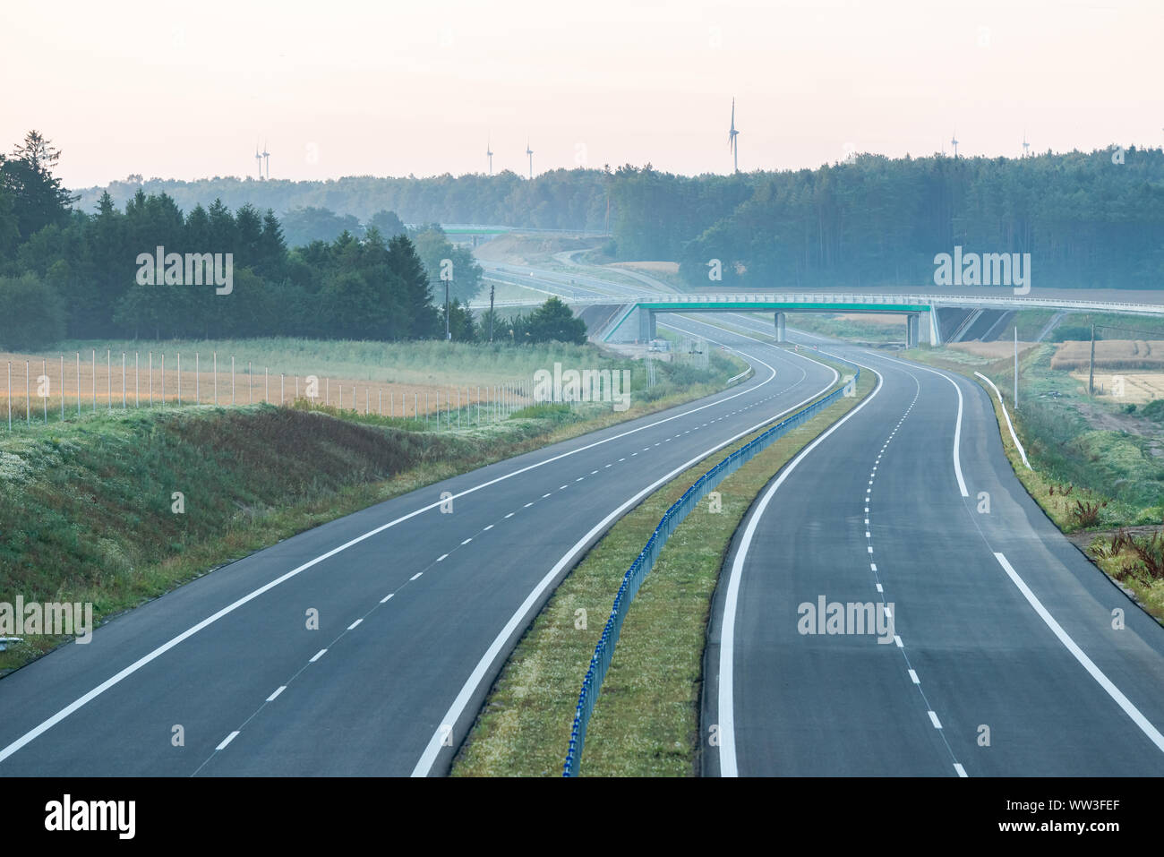 empty two-lane road stretching out into the horizon Stock Photo