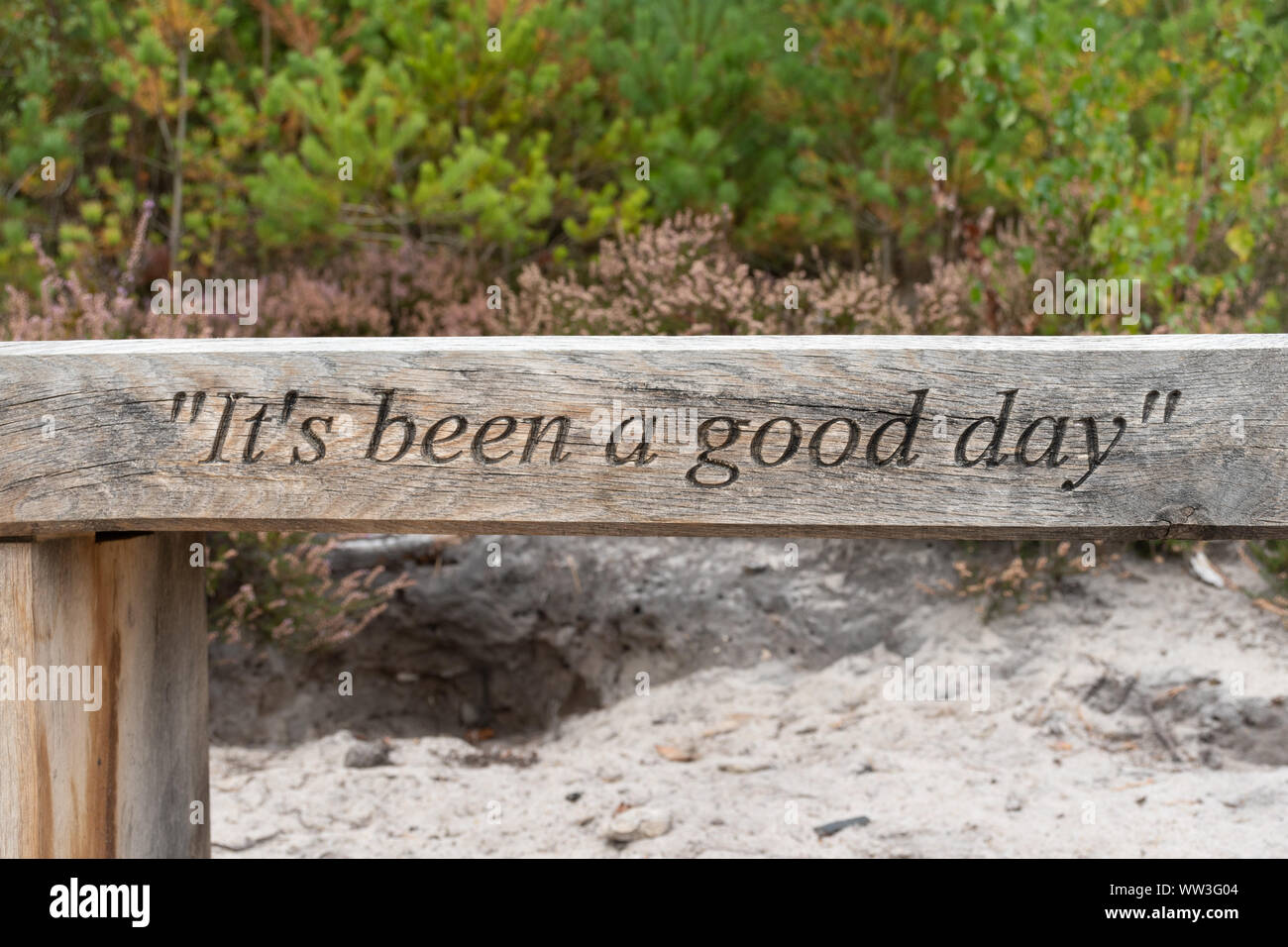 Wooden bench with the words 'it's been a good day' at RSPB Farnham Heath nature reserve, Surrey, UK Stock Photo