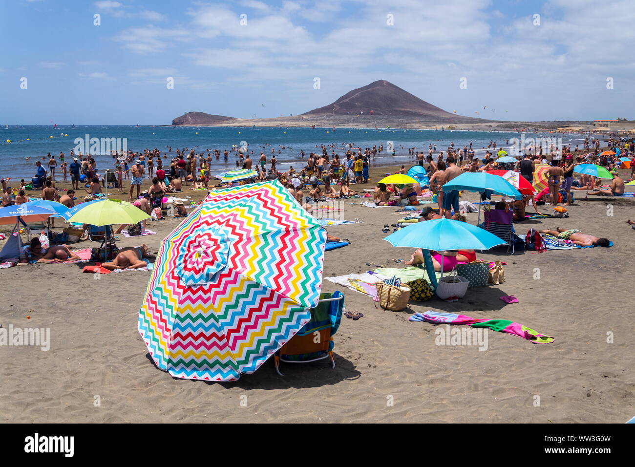 EL MEDANO, SPAIN - JULY 7 2019: People swimming and sunbathing on Playa El Medano beach on July 7, 2019 in El Medano, Spain. Stock Photo