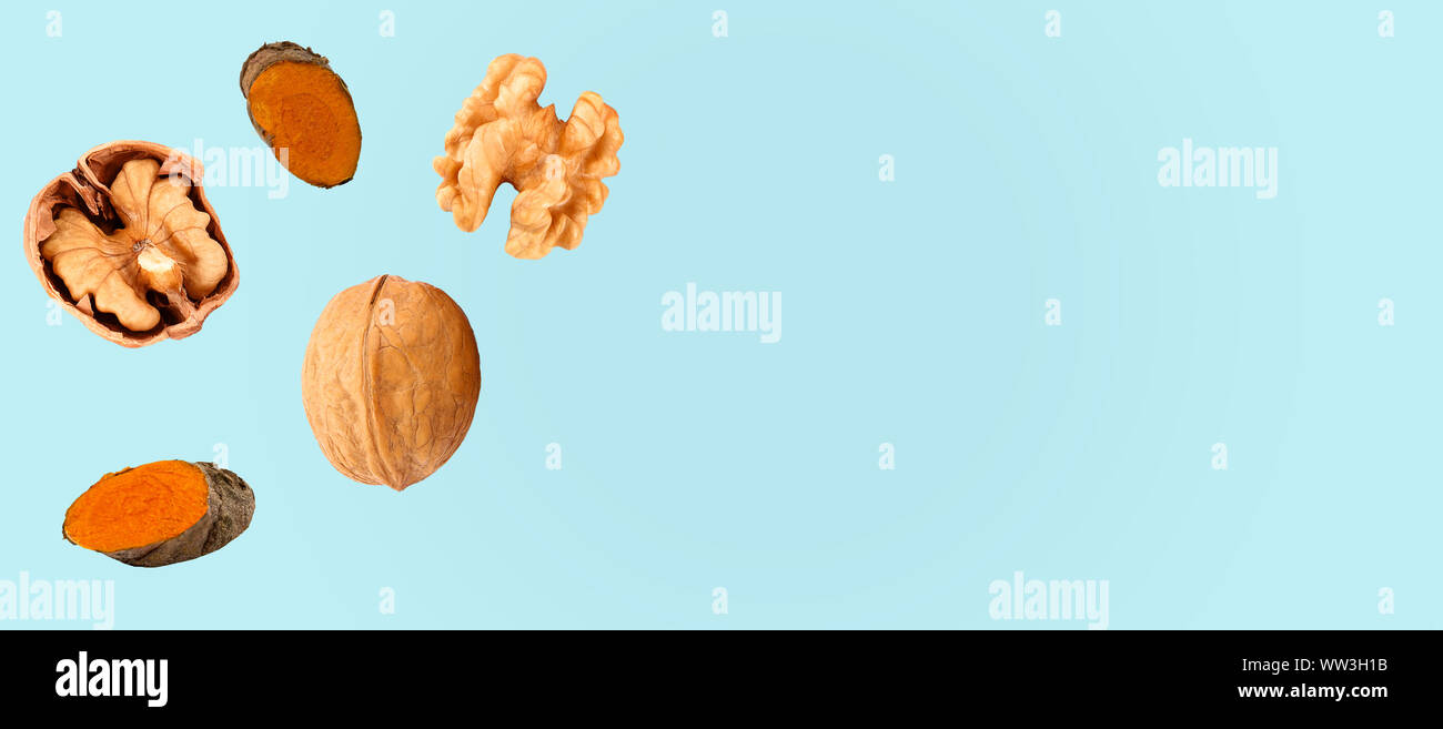 Composition with walnuts and turmeric on color background, top view Stock Photo