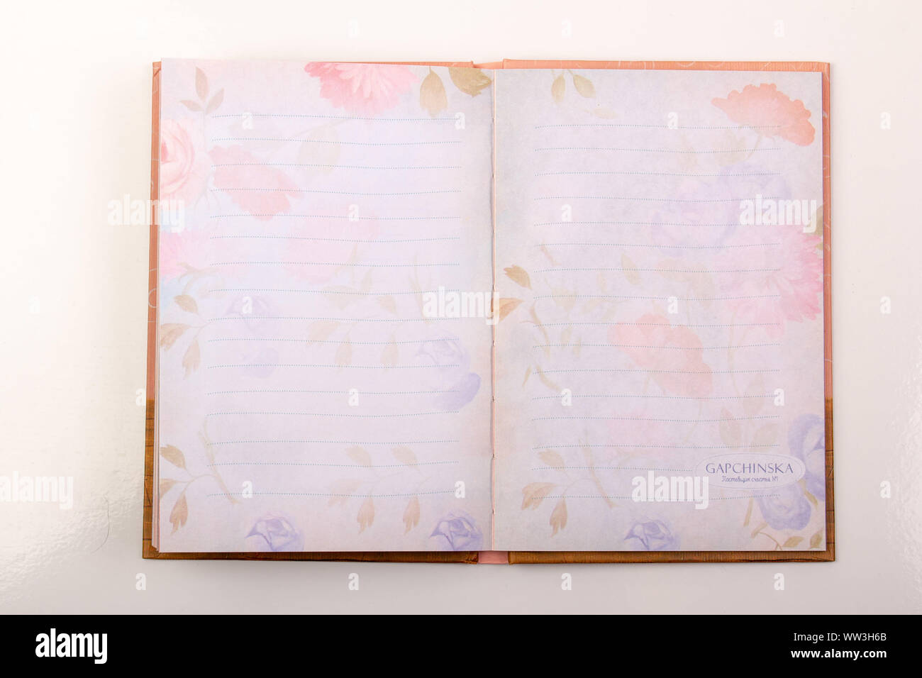 An open notebook on the table on a white background Stock Photo