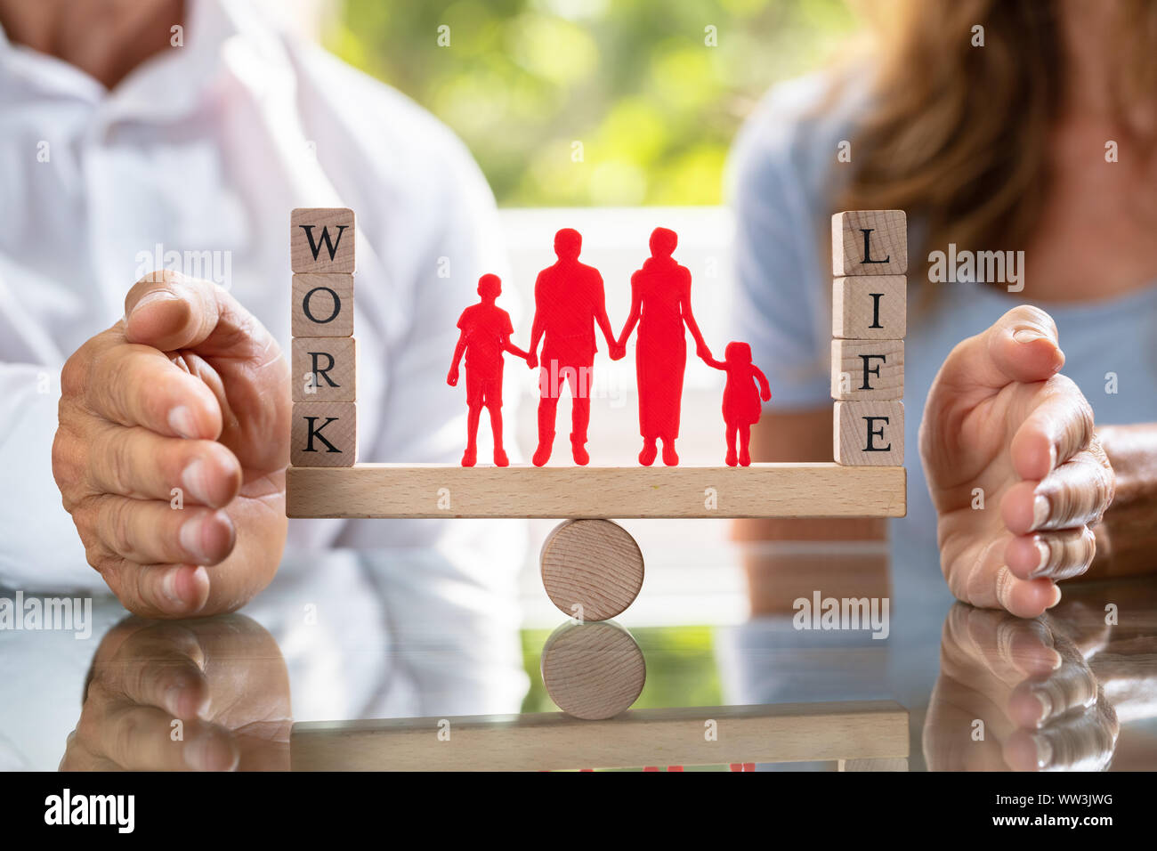 Mid-section Of Couple Protecting Work And Life Balance With Family ...