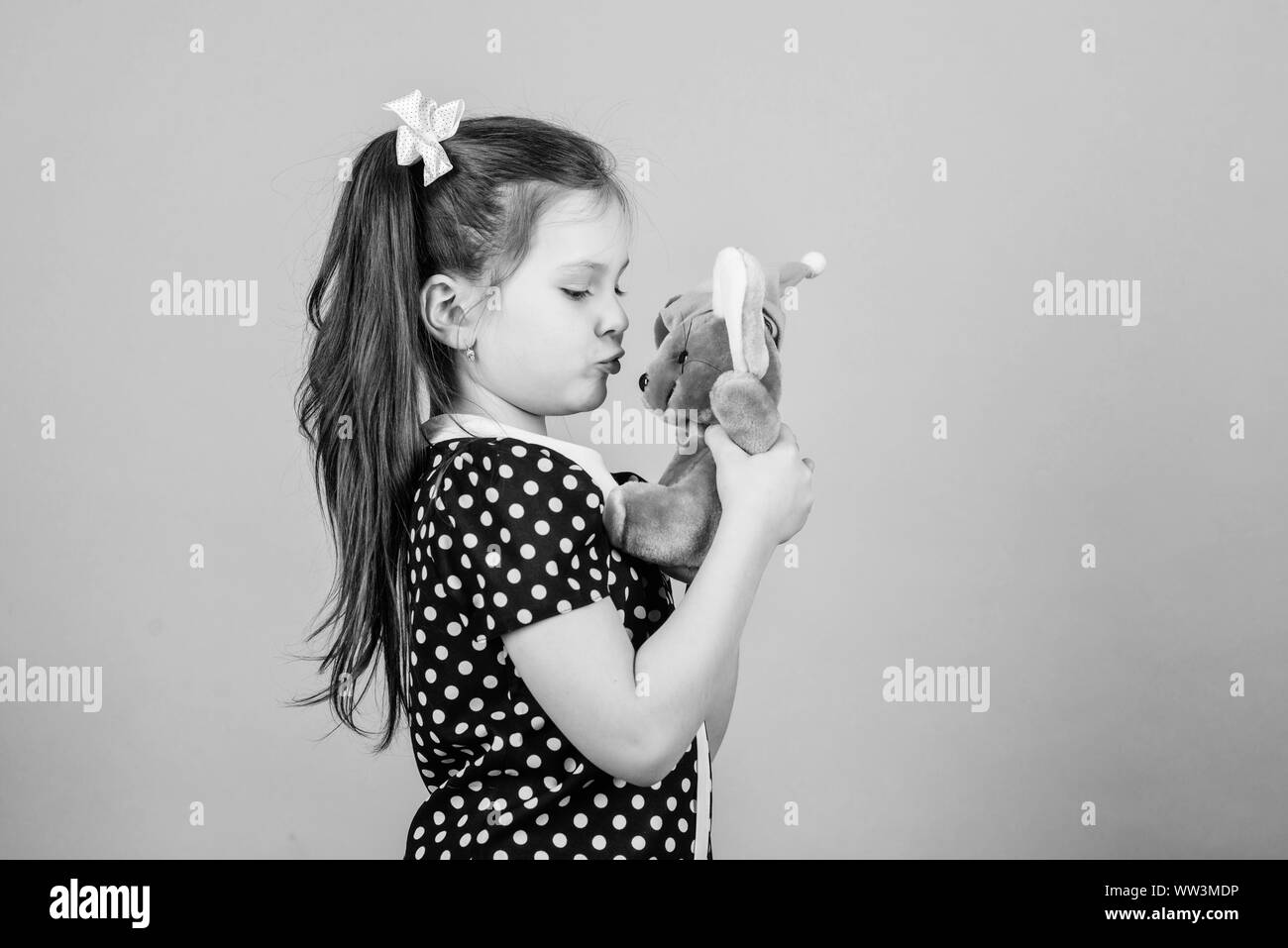 Childhood concept. Lovely small girl with favorite toy. Kindergarten and educational games. Spreading love. Kid cute girl play with soft toy mouse. Happy childhood. Child care. Sweet childhood. Stock Photo