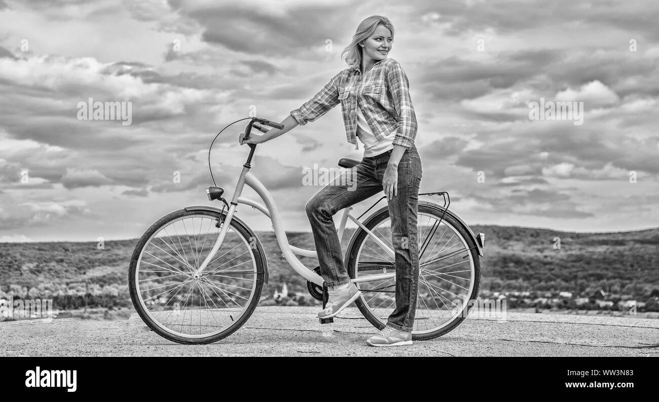 woman-rides-bicycle-sky-background-benefits-of-cycling-every-day-keep
