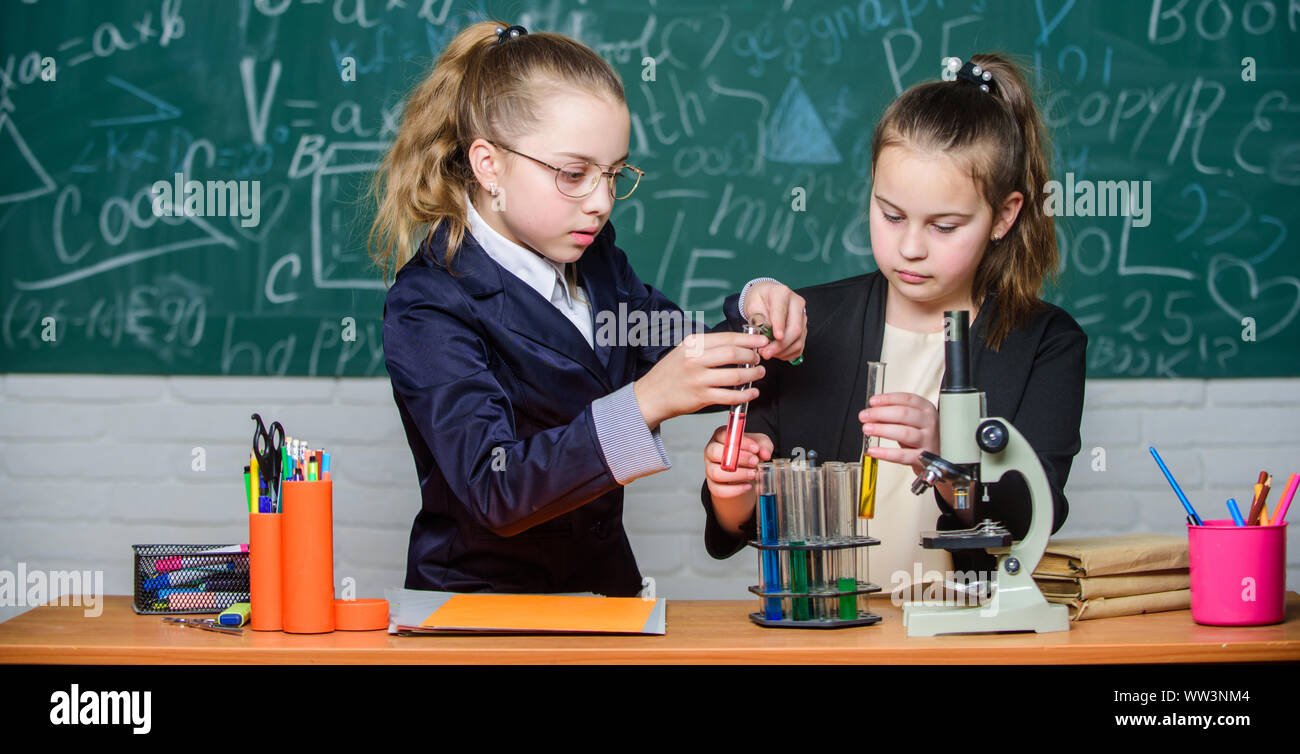 Little Science Lab science experiments in laboratory. Chemistry research. Little girls in ...