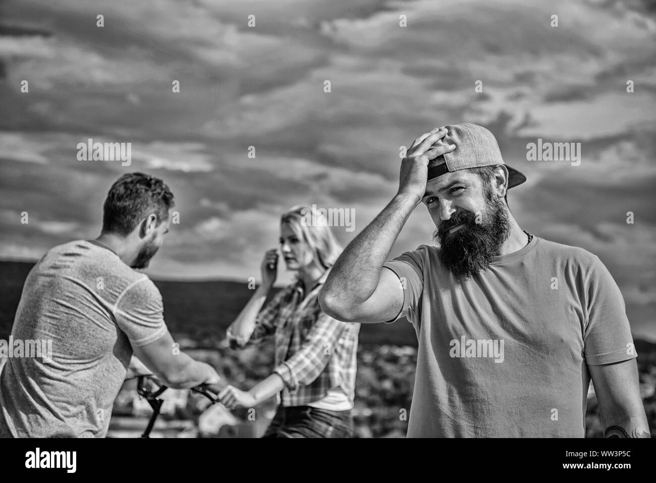 No romantic in his life. Man hipster feels lonely couple dating behind him. Man regret not asked her go out. Now she dating with another guy. Hipster regretful face in front of couple in love. Stock Photo