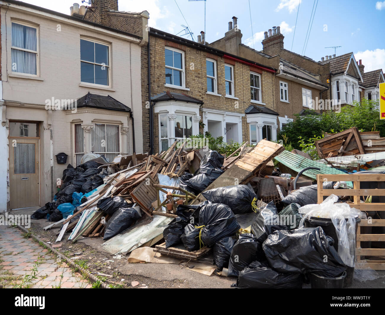 Throwing out waste during house refurbishment, Enfield, London, UK Stock Photo
