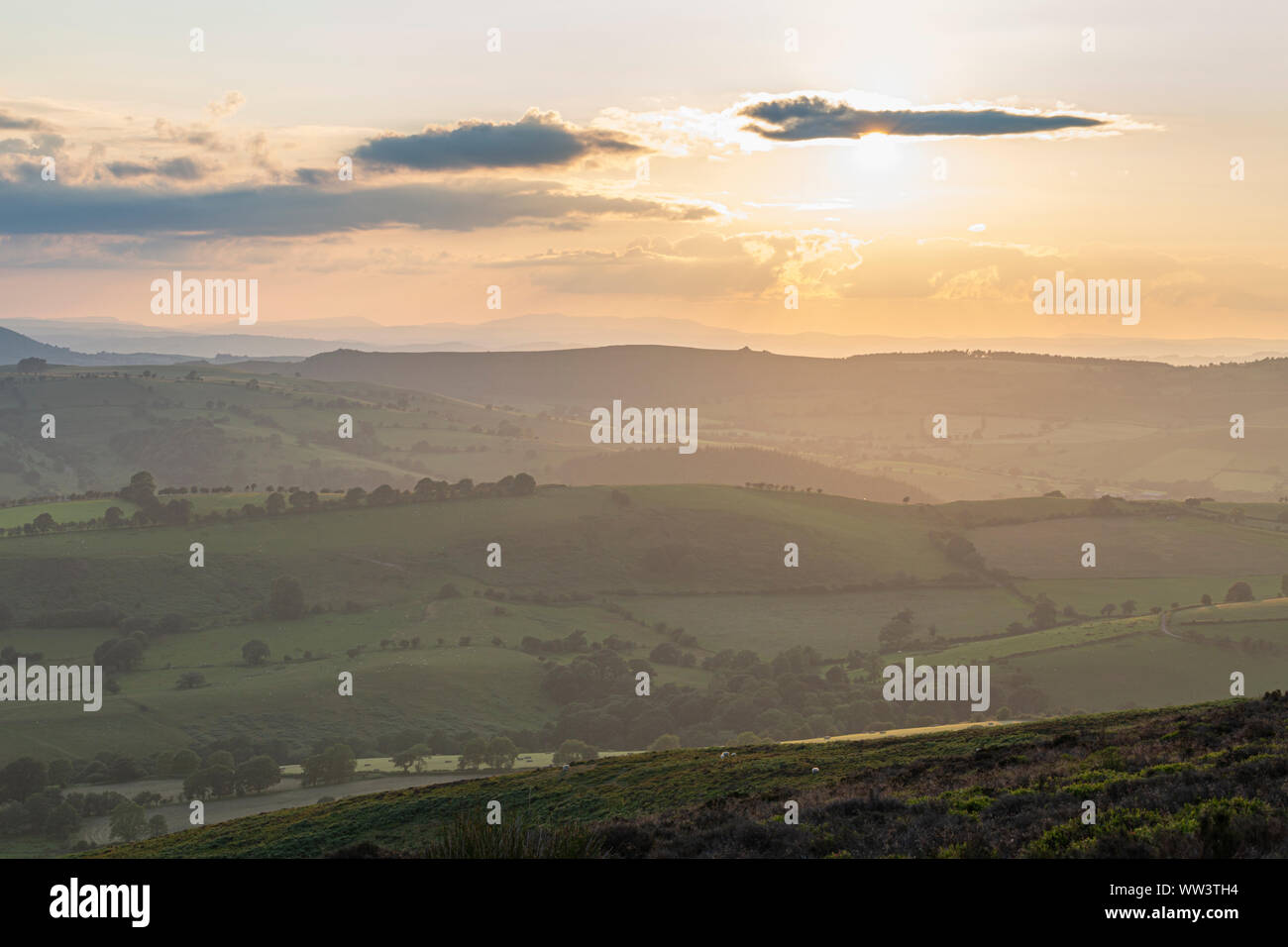 Sunset clouds over rolling farming fields in United Kingdom Stock Photo