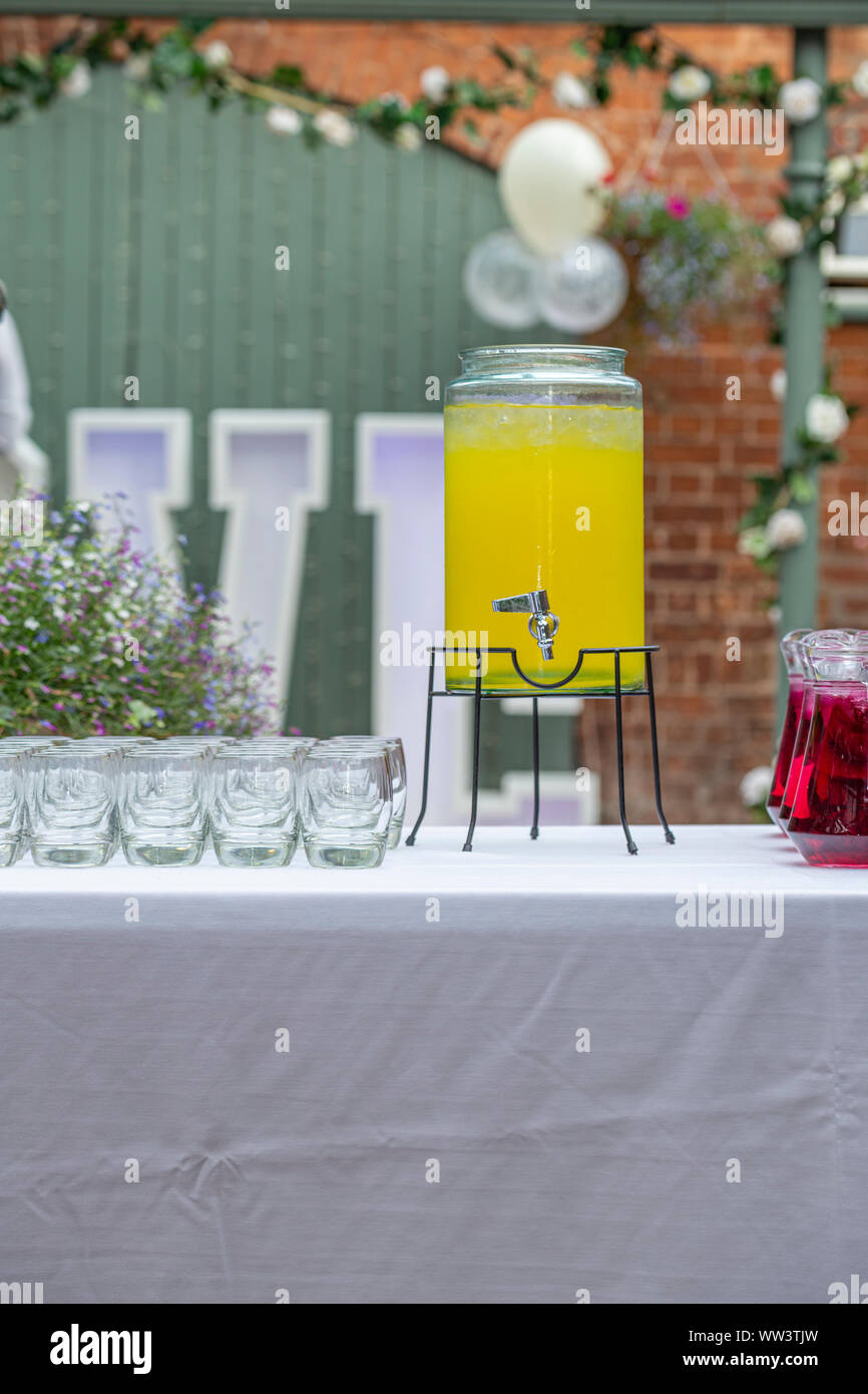 fruit punch in a drink dispenser at a party Stock Photo - Alamy