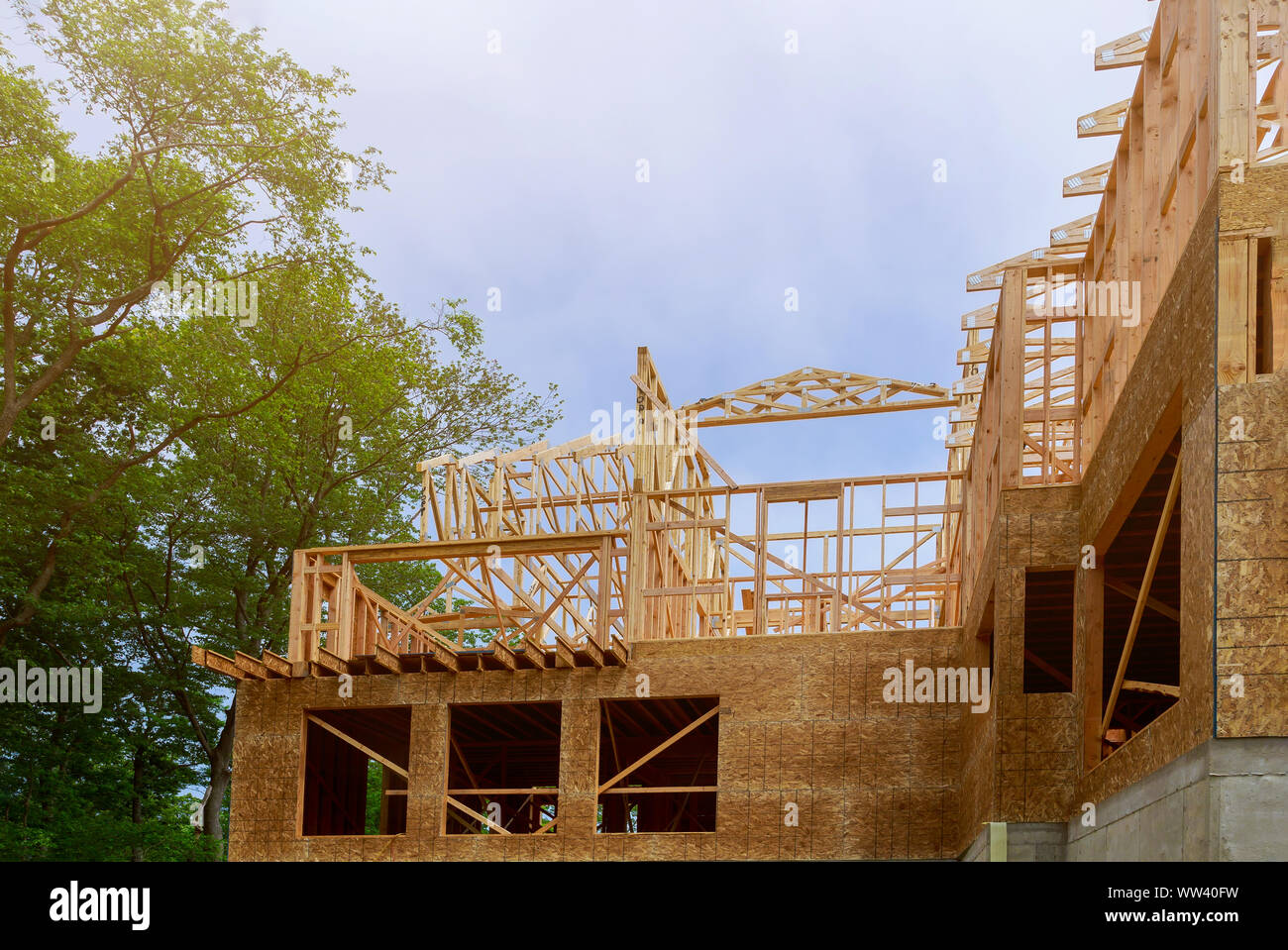 Looking up at new construction beams under a clear blue sky with ...