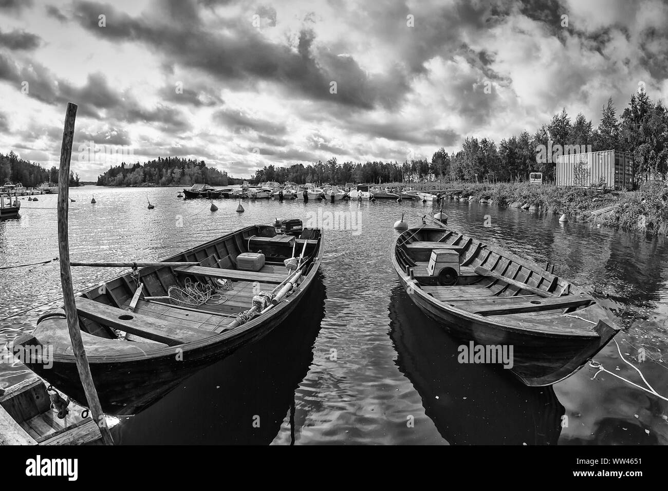 Two old wooden fishing boats wait for the fishermen at the harbour of Kalajoki, Finland. These traditional fishing boats are actually used on sea. Stock Photo