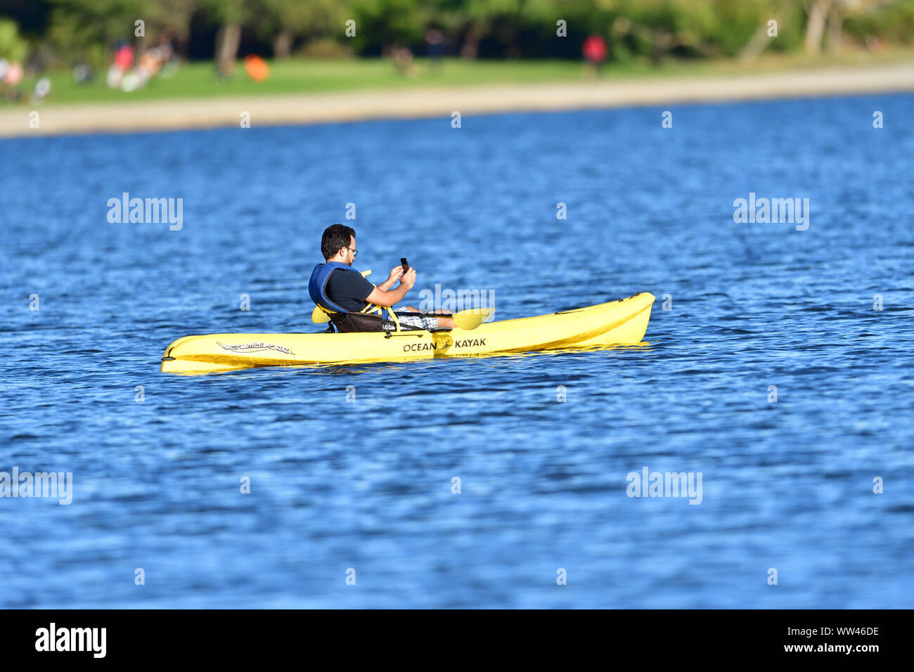 A Tourist taking a selfie in the mid-lake on his kayak Stock Photo