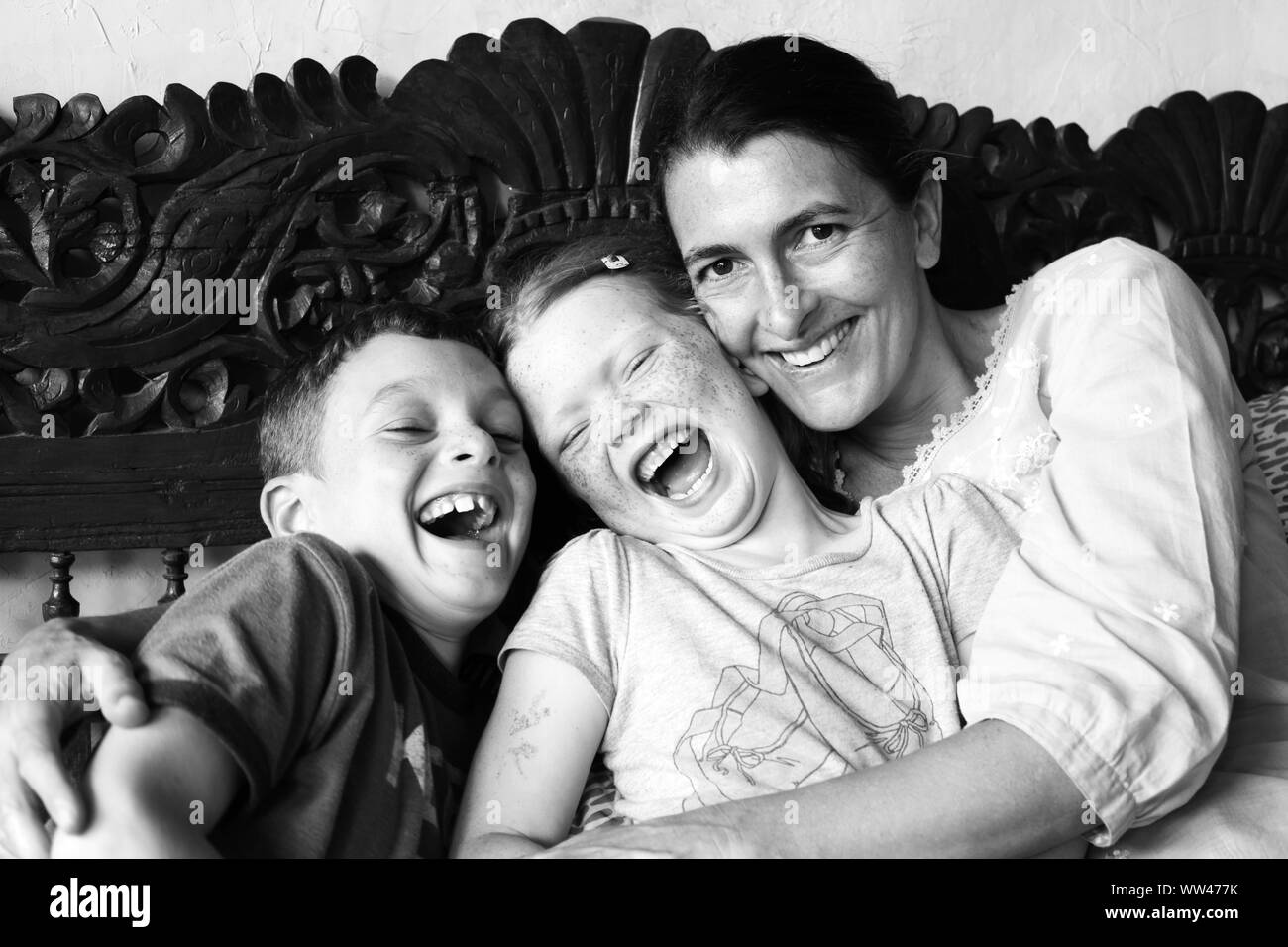 A laughing happy family caught in a moment of happiness in Indonesia, Bali. Stock Photo