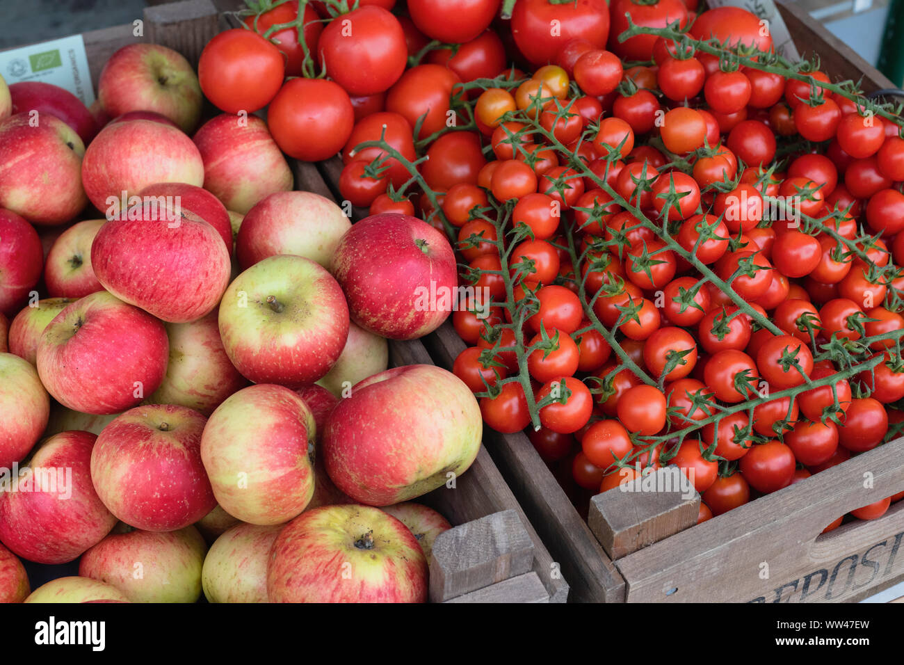 Apples and organic tomatoes for sale outside the greengrocers shop in Ledbury, Herefordshire. England Stock Photo