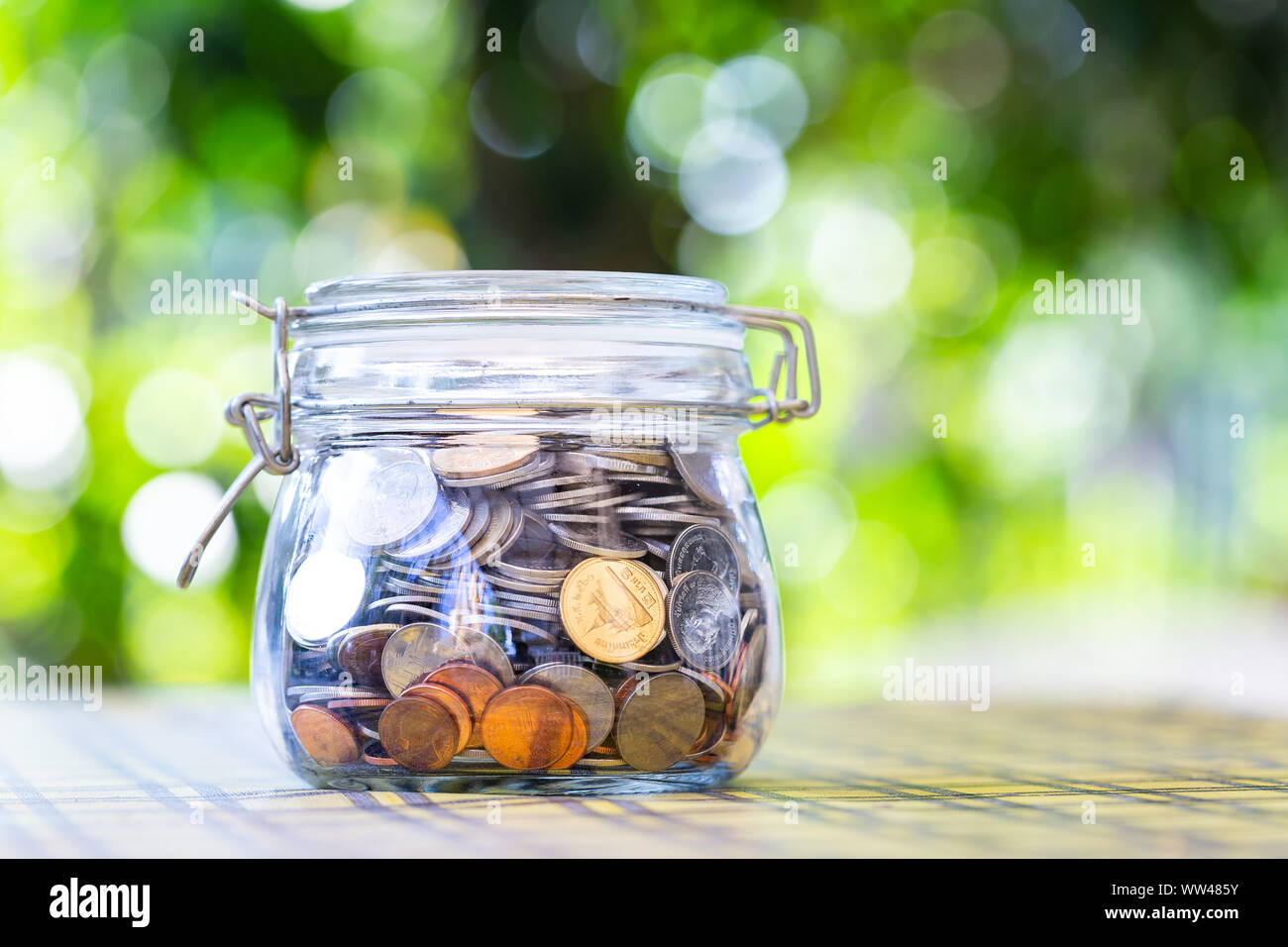 Many coins in glass jar, saving. concept business. Stock Photo