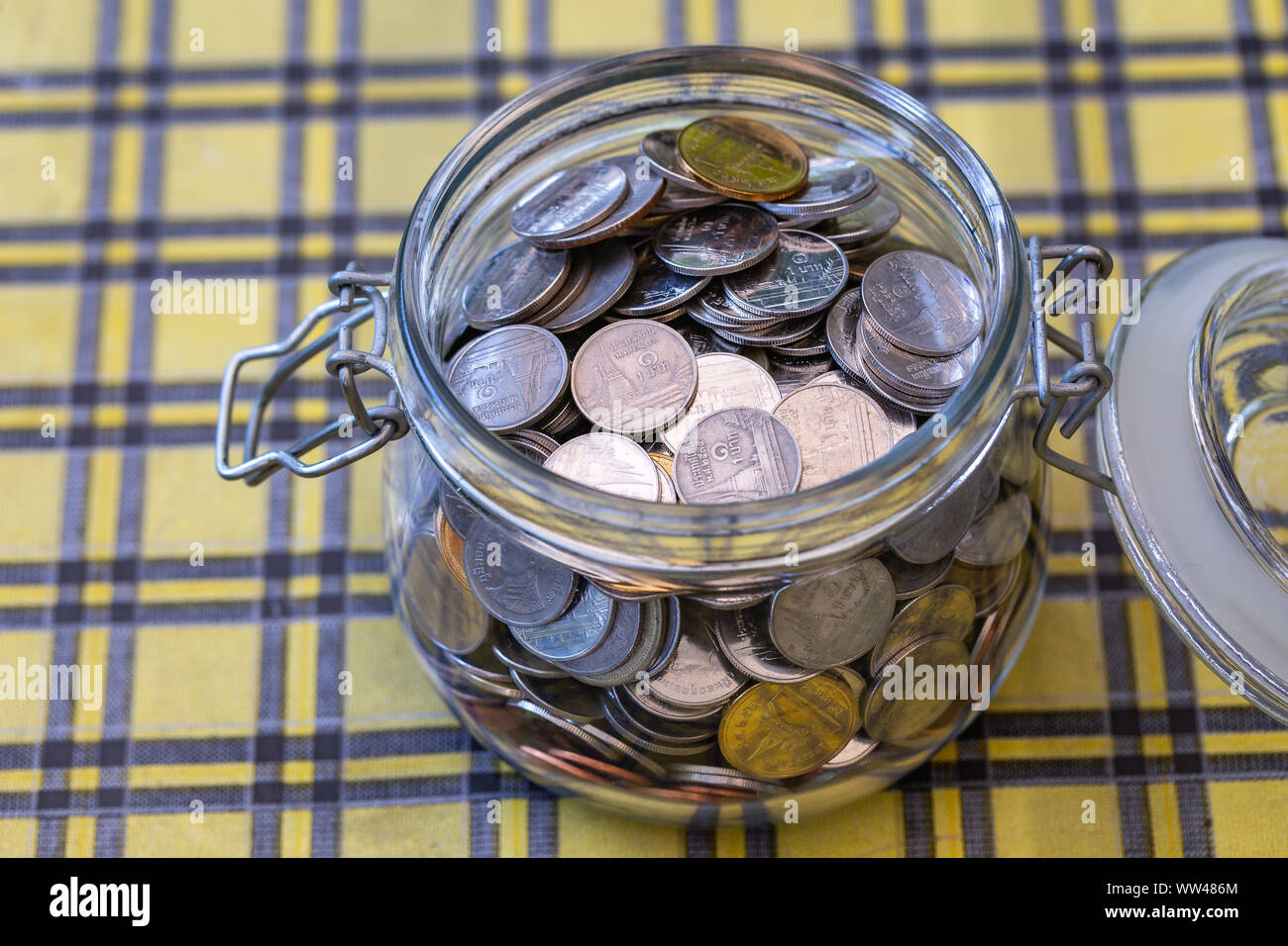 Many coins in glass jar, saving. concept business. Stock Photo