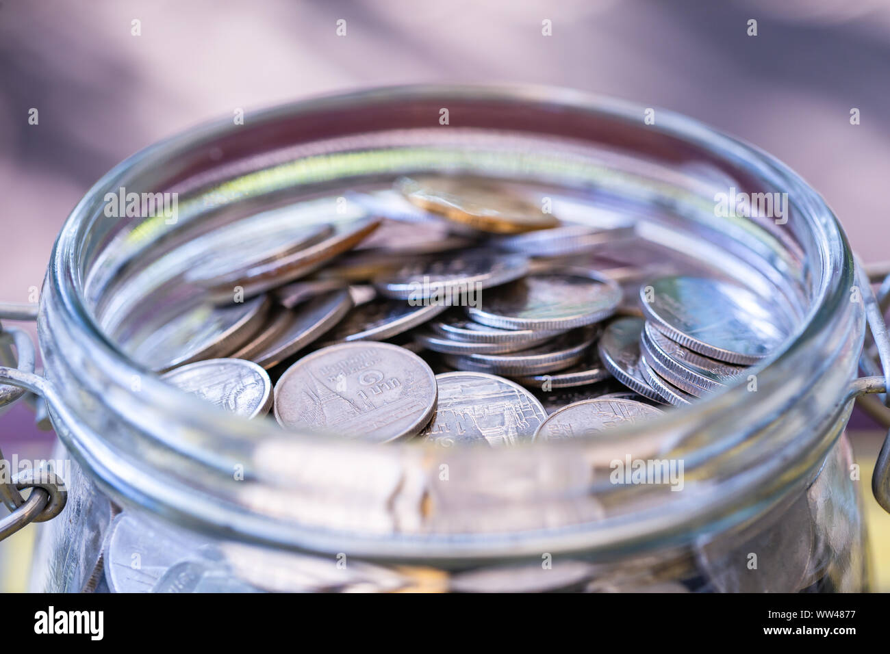 Many coins in glass jar, saving. concept business Stock Photo - Alamy