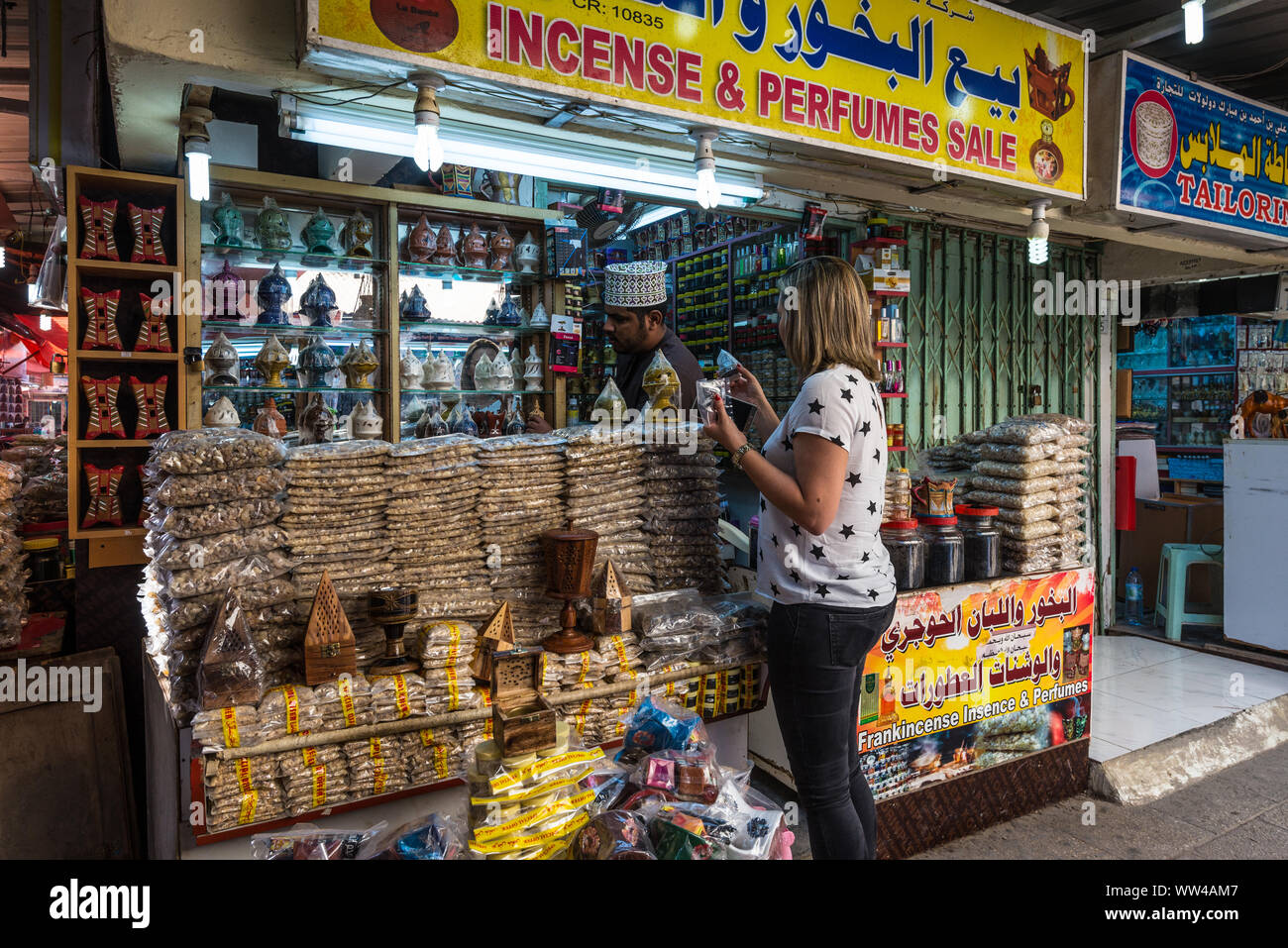 Salalah, Sultanat of Oman - November 12, 2017: Woman tourist buys souvenirs at the Al Husn or Haffa Souk in Salalah, Oman, Indian Ocean. Stock Photo