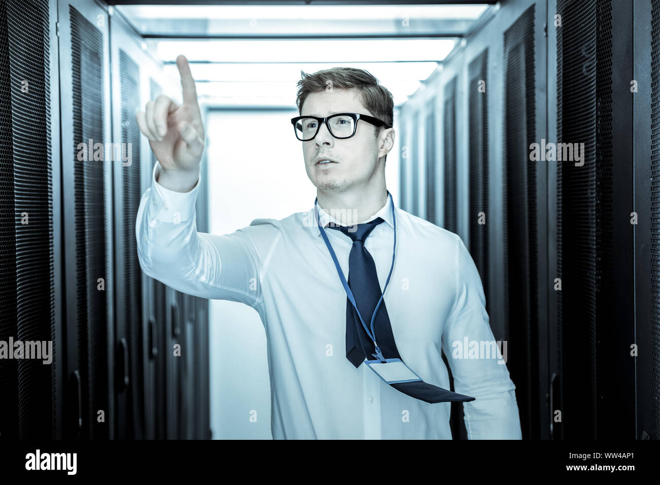 Tall security guard in a blue shirt looking involved Stock Photo Alamy