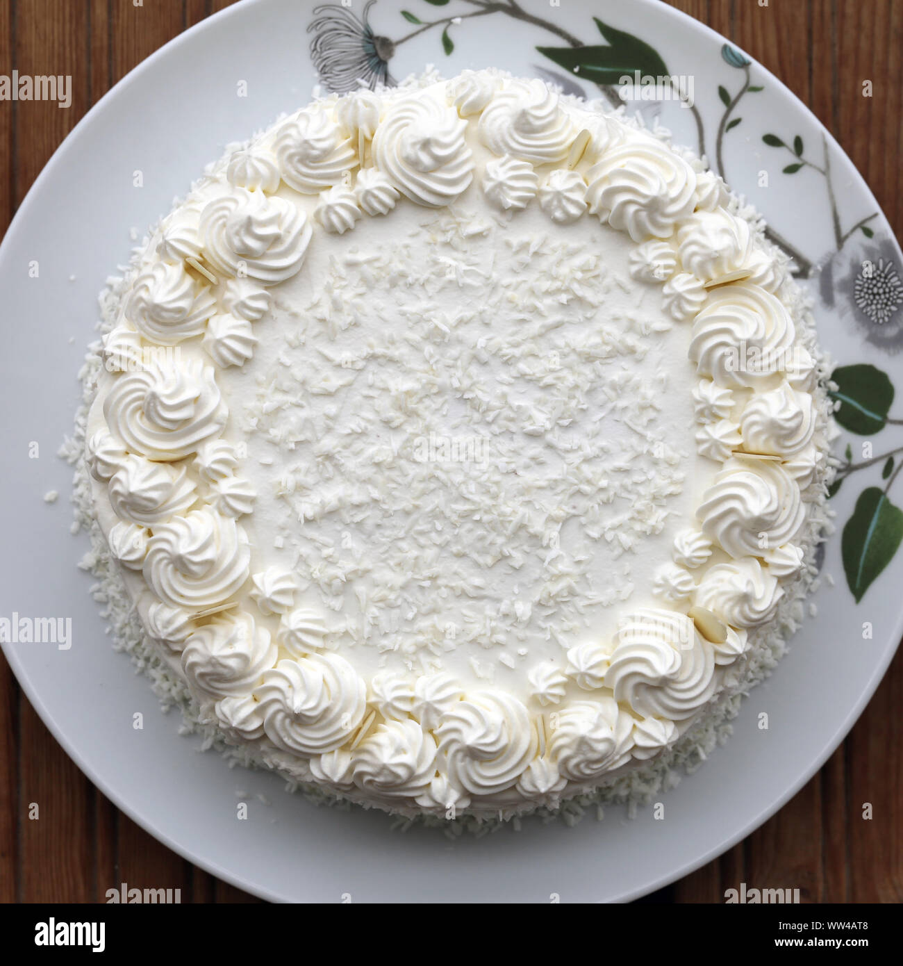 Homemade Raffaello cake (coconut almond cake) in a closeup. Decorated with  white whipped cream, coconut and almond slices. Beautiful, detailed pastry  Stock Photo - Alamy